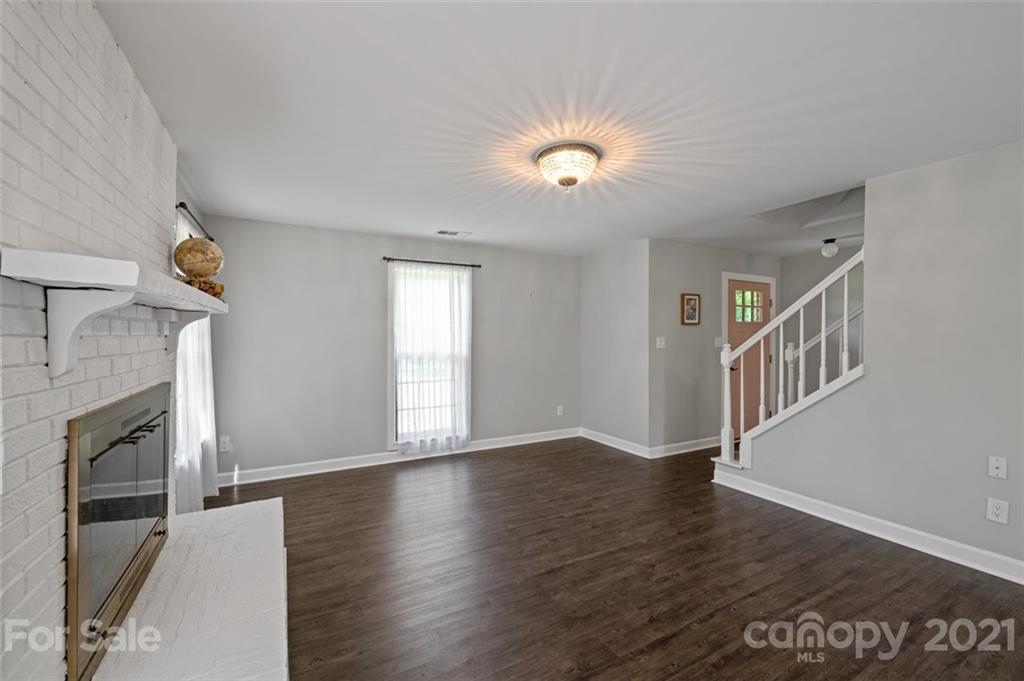 10017 Sardis Oaks Road Charlotte, NC 28270 - Photo 8 of 31 a view of an empty room with window and wooden floor