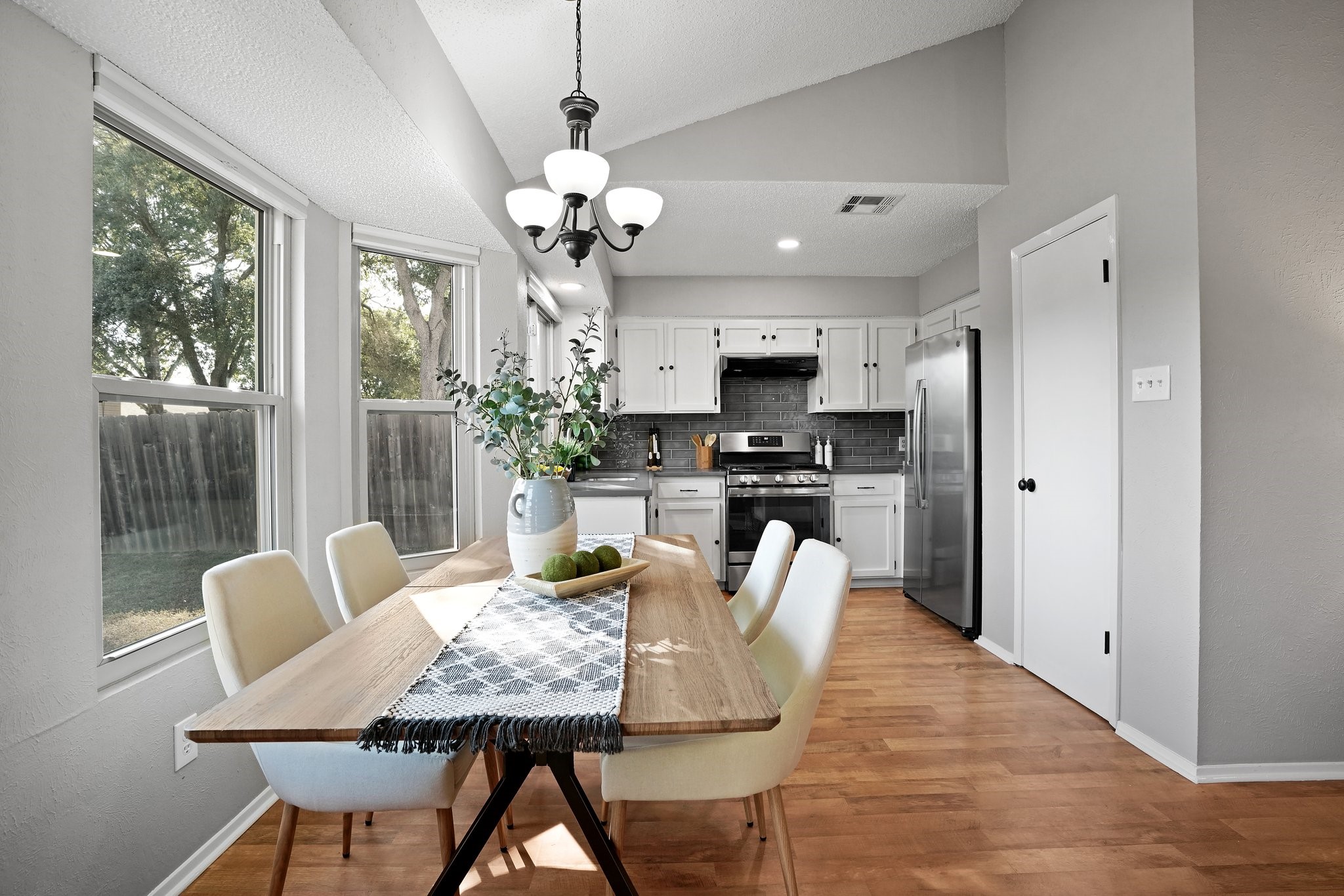 3805 Tamil Street Austin, TX 78749 - Photo 14 of 27 a view of a dining room with furniture a livingroom and chandelier