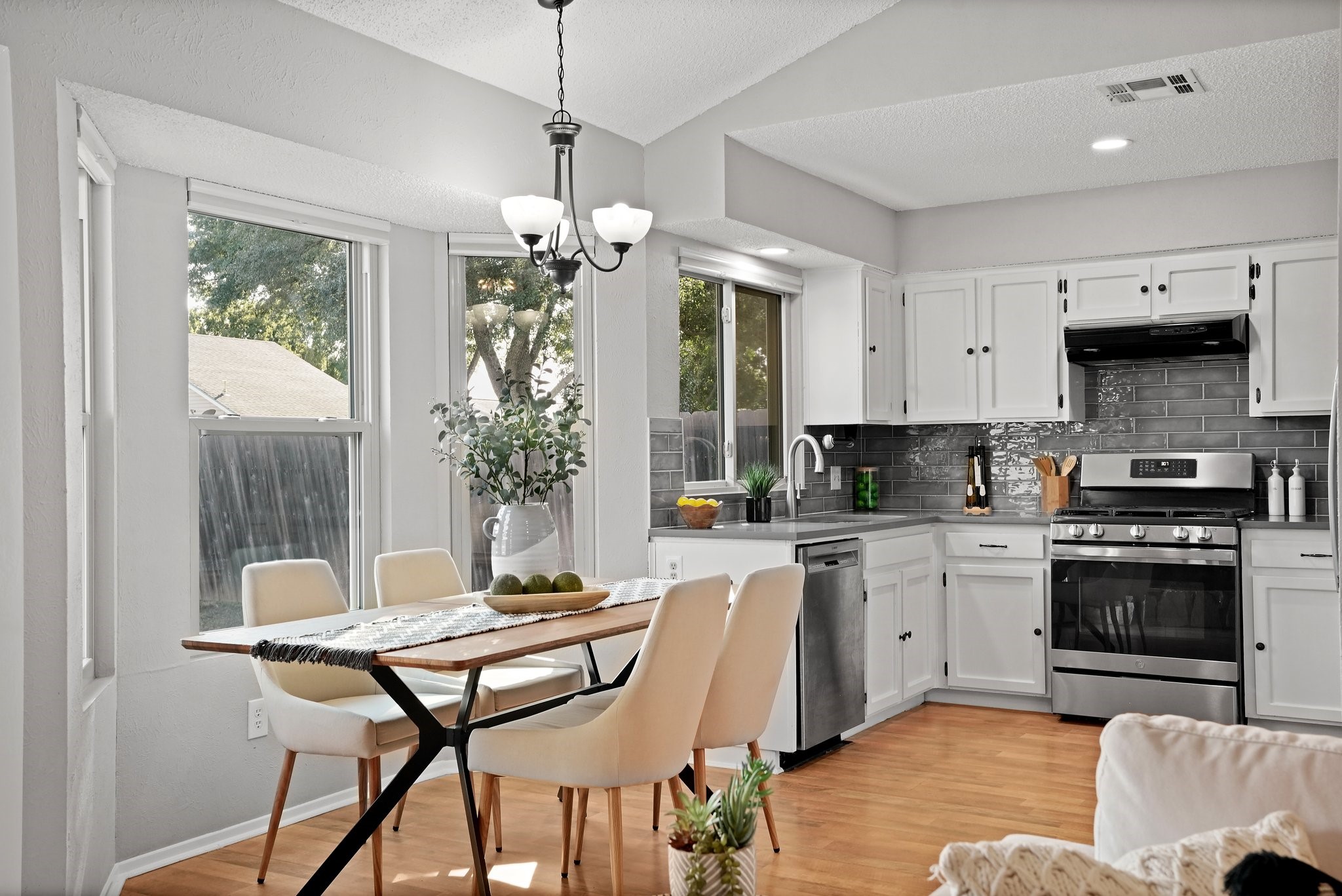 3805 Tamil Street Austin, TX 78749 - Photo 15 of 27 a kitchen with stainless steel appliances granite countertop a stove top oven a sink a dining table and chairs