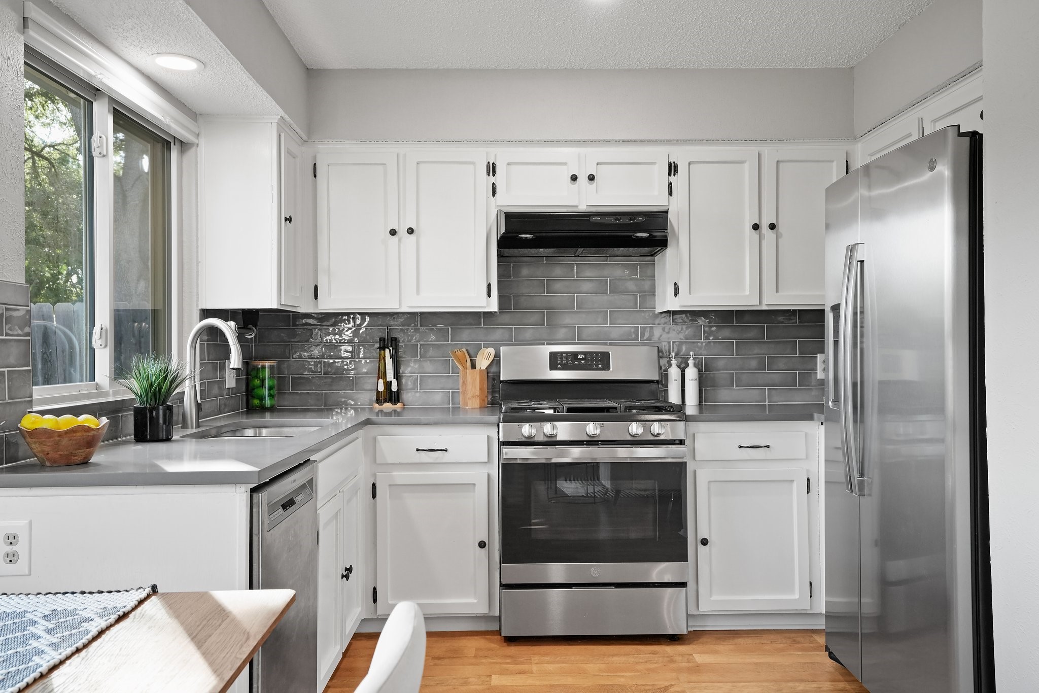 3805 Tamil Street Austin, TX 78749 - Photo 16 of 27 a kitchen with stainless steel appliances white cabinets and a stove top oven