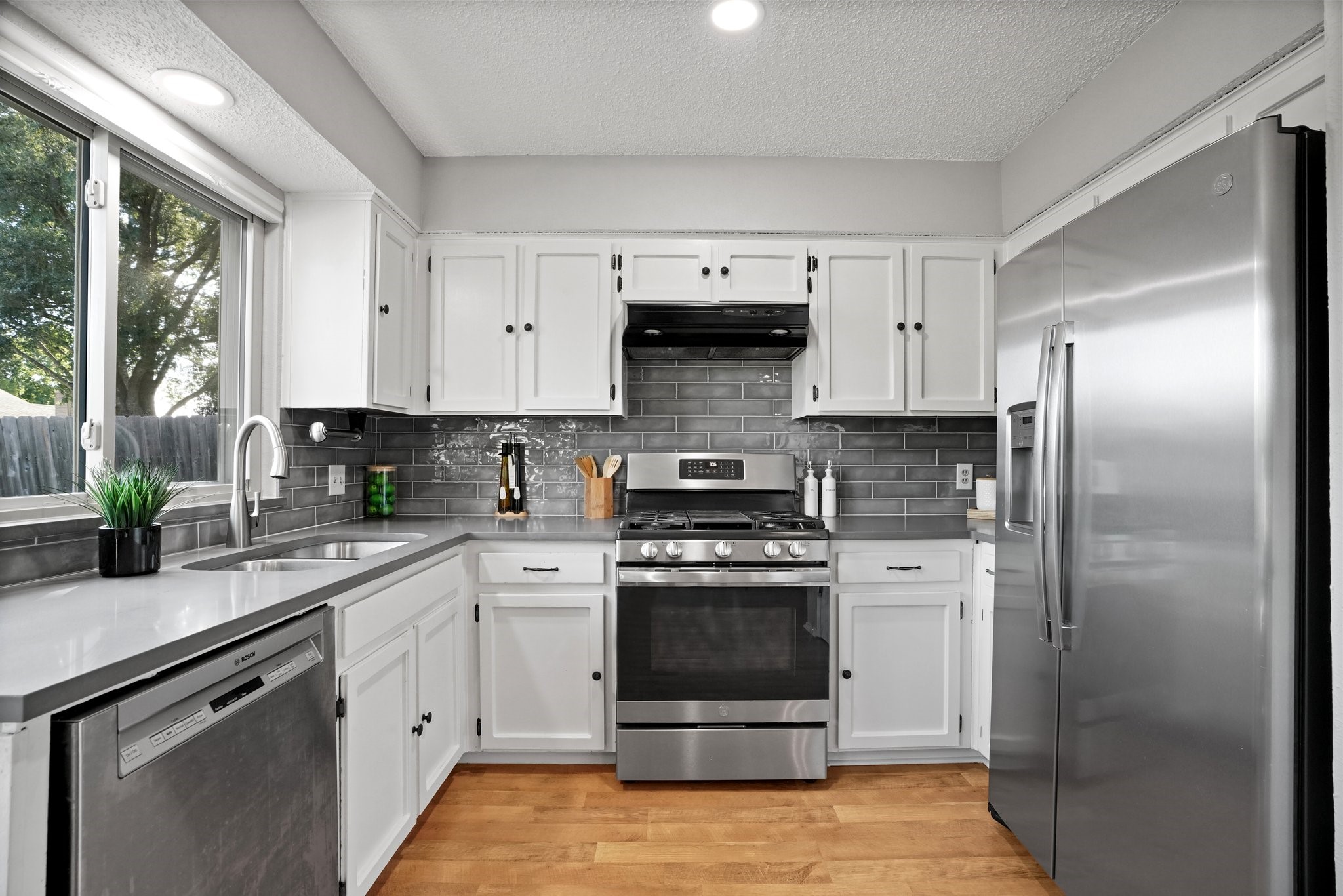 3805 Tamil Street Austin, TX 78749 - Photo 17 of 27 a kitchen with white cabinets and stainless steel appliances