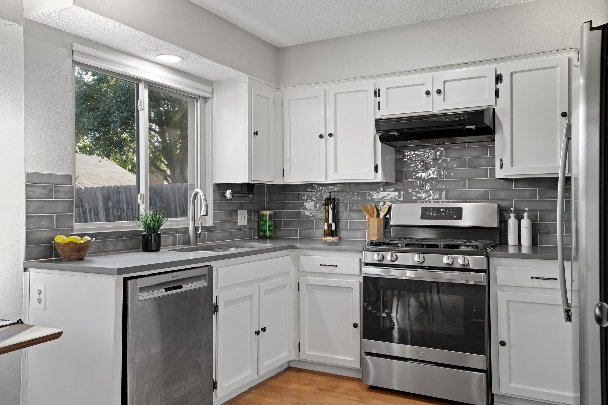 3805 Tamil Street Austin, TX 78749 - Photo 2 of 27 a kitchen with stainless steel appliances granite countertop a stove a sink and a white cabinets