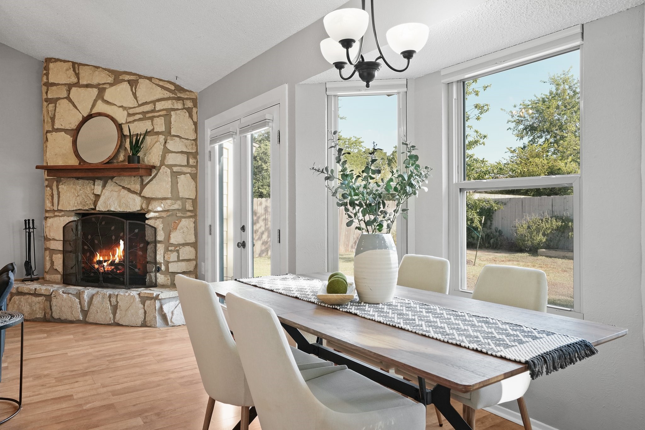 3805 Tamil Street Austin, TX 78749 - Photo 3 of 27 a dining room with furniture a fireplace and a chandelier