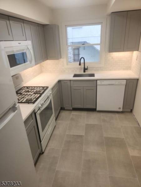 204 Bloomfield Avenue, Unit A Montclair, NJ 07042 - Photo 3 of 9 a kitchen with a sink stove and cabinets