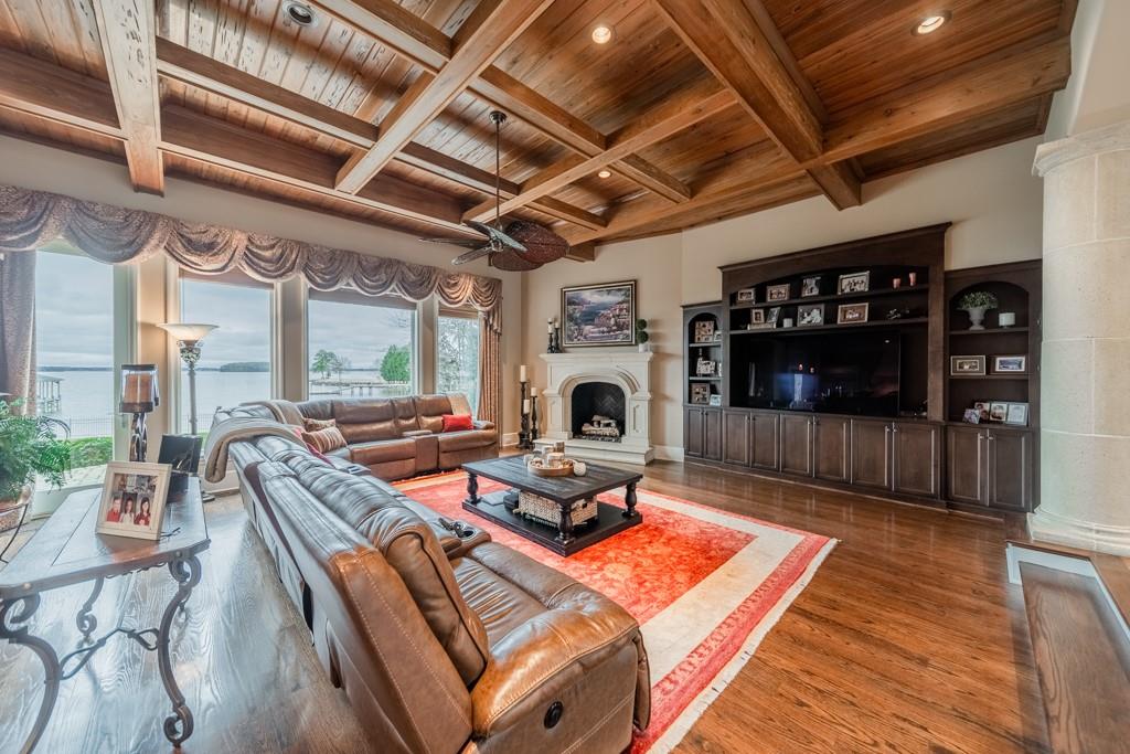 16339 Jetton Road Cornelius, NC 28031 - Photo 14 of 48 a living room with furniture a flat screen tv and a fireplace