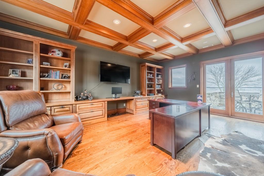 16339 Jetton Road Cornelius, NC 28031 - Photo 30 of 48 a living room with furniture a flat screen tv and a floor to ceiling window