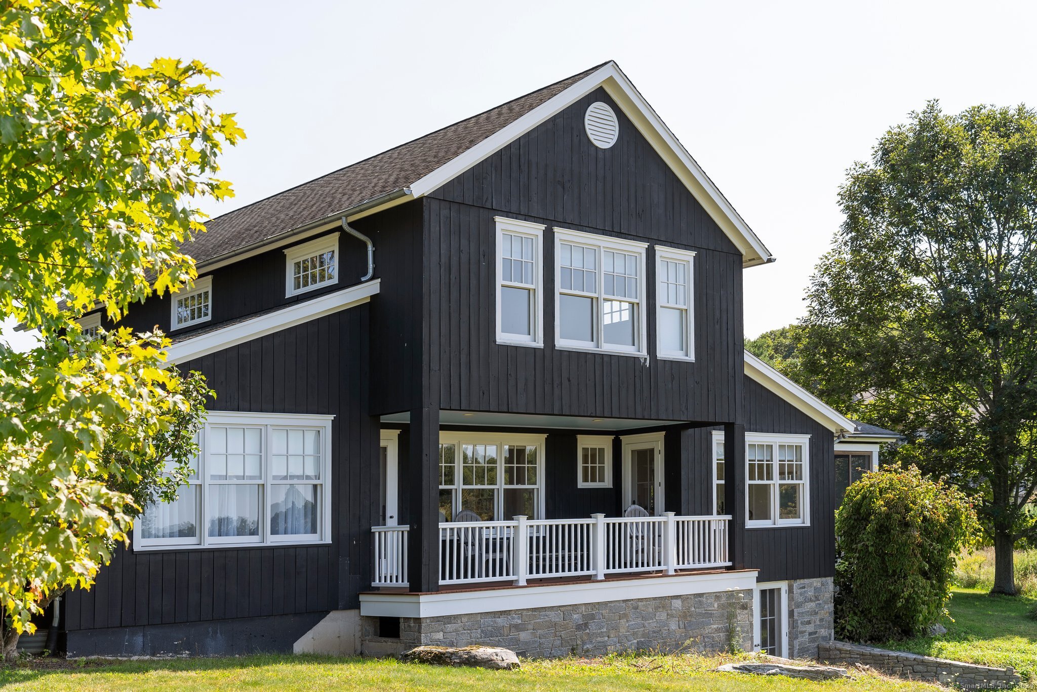 74 Tanner Hill Road Warren, CT 06777 - Photo 20 of 40 a front view of a house with a yard garage and outdoor seating
