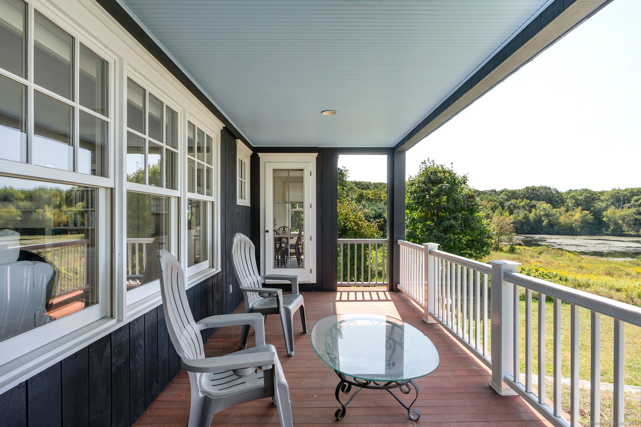 74 Tanner Hill Road Warren, CT 06777 - Photo 21 of 40 a view of a balcony with chair and glass door