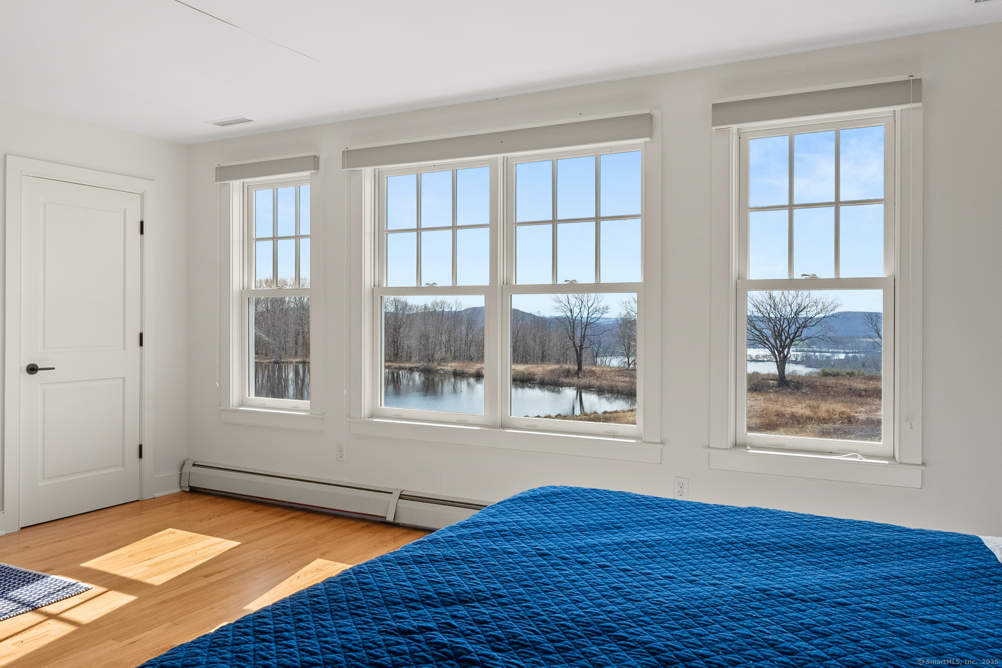 74 Tanner Hill Road Warren, CT 06777 - Photo 32 of 40 a view of an empty room with wooden floor and a window