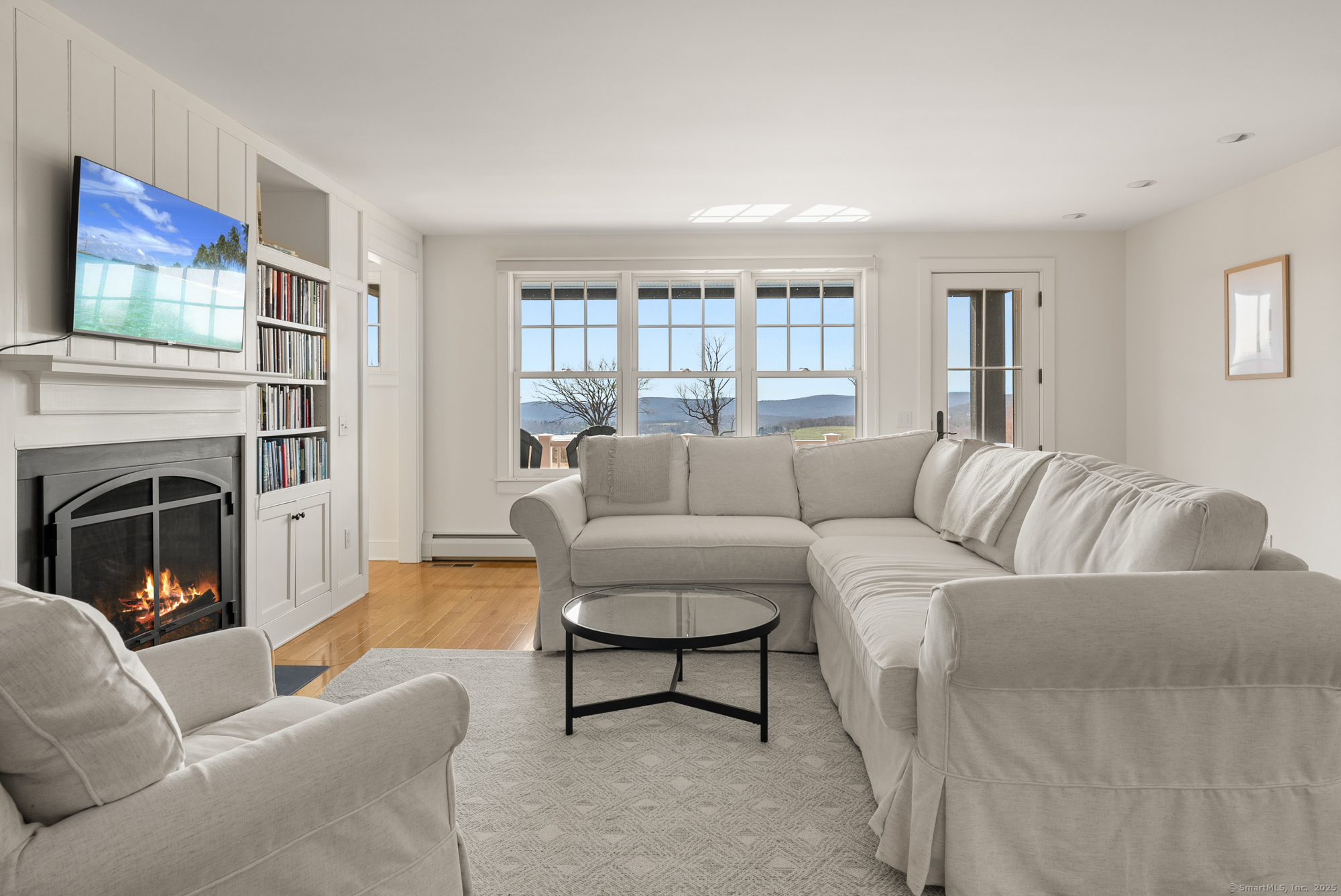 74 Tanner Hill Road Warren, CT 06777 - Photo 9 of 40 a living room with furniture a fireplace and a window
