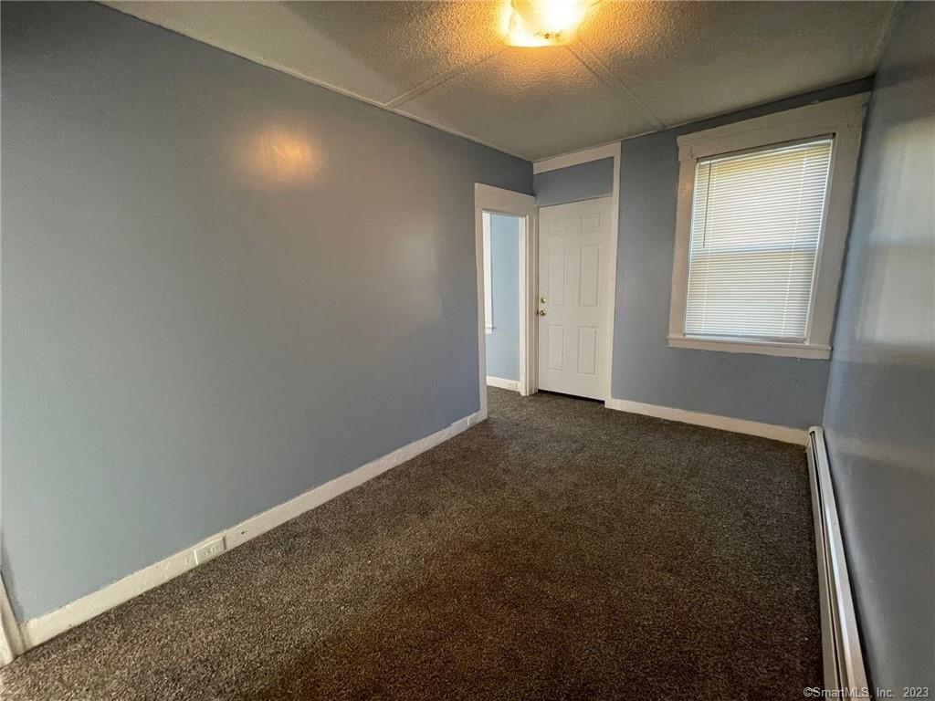 79 River Street, Unit 79 Sprague, CT 06330 - Photo 13 of 25 an empty room with a empty space and windows