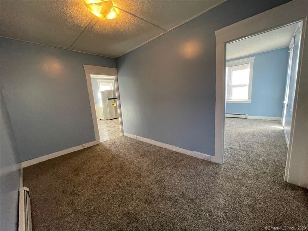 79 River Street, Unit 79 Sprague, CT 06330 - Photo 14 of 25 an empty room with windows and entrance
