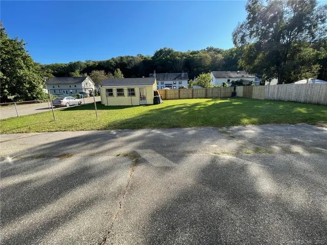 a view of an house with a big yard