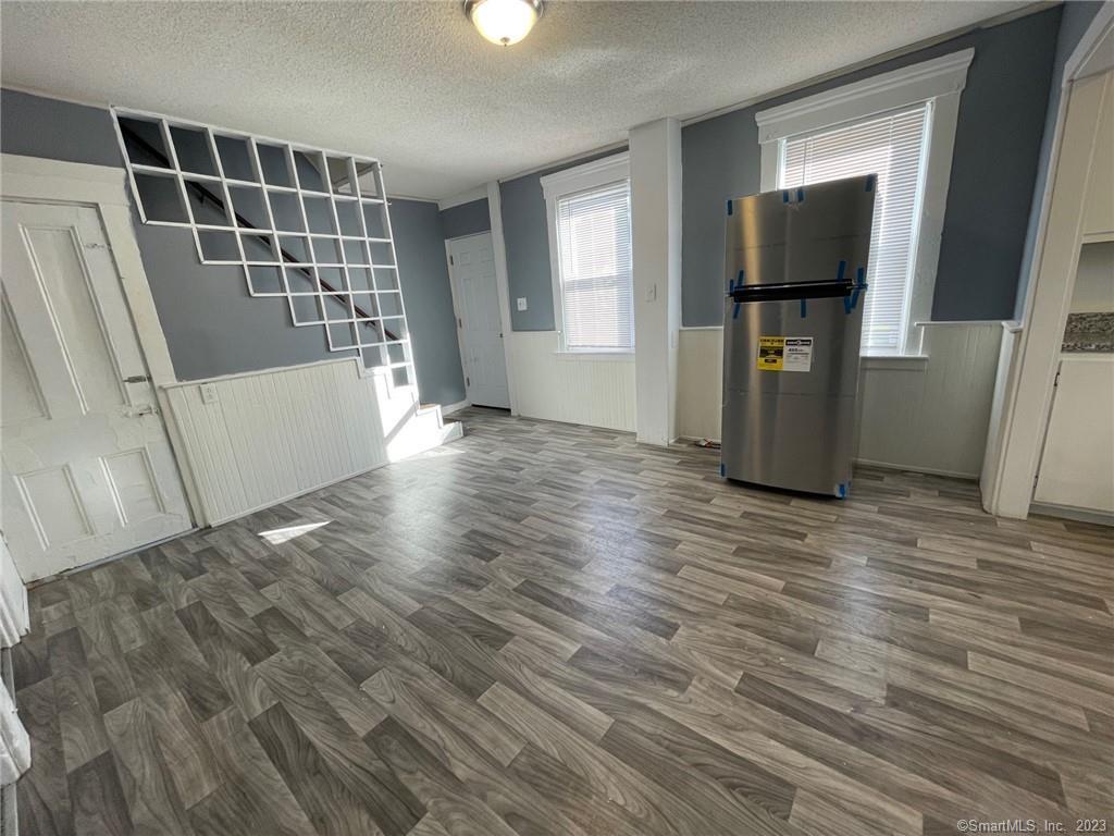 79 River Street, Unit 79 Sprague, CT 06330 - Photo 7 of 25 a view of empty room with wooden floor and fan