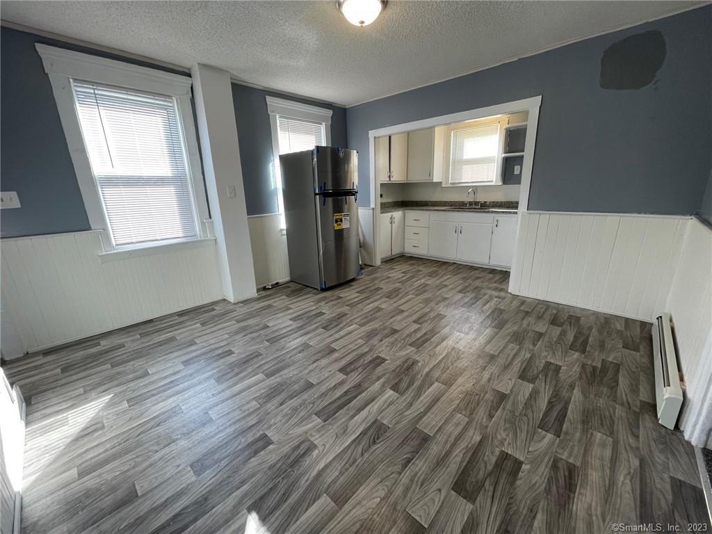 79 River Street, Unit 79 Sprague, CT 06330 - Photo 8 of 25 wooden floor in an empty room with a window