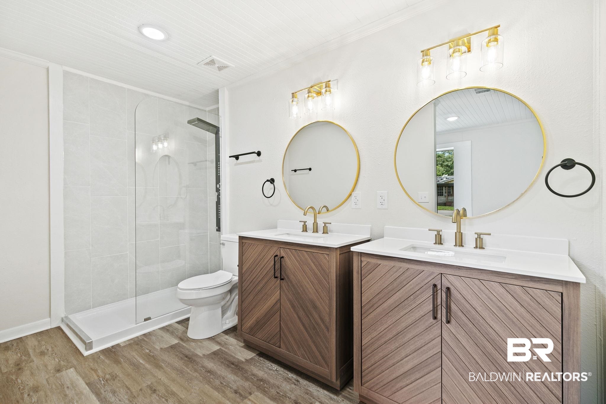507 Byrne Street Bay Minette, AL 36507 - Photo 24 of 40 Bathroom with vanity, a shower with shower door, hardwood / wood-style floors, ornamental molding, and toilet