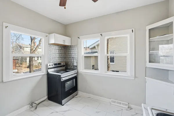 a kitchen with granite countertop a stove and a sink