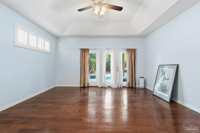 a living room with furniture a flat screen tv and a window