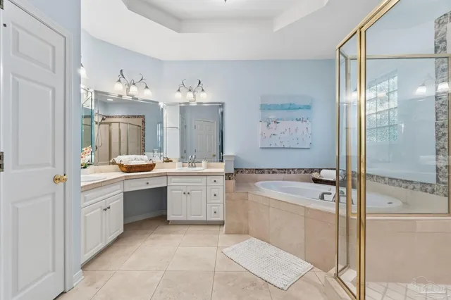 a bathroom with a toilet a sink a vanity a mirror a vanity and window