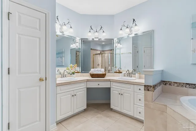 a bathroom with a granite countertop sink a toilet a mirror a bathtub and shower