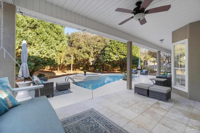 an aerial view of residential house with outdoor space and swimming pool