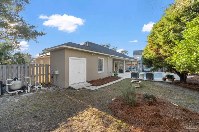 an aerial view of a house with a yard and lake view