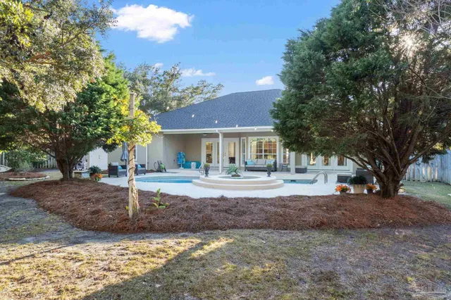 an aerial view of a house with a yard and outdoor seating