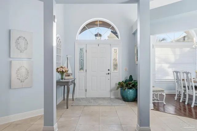 a living room with furniture a fireplace and a chandelier