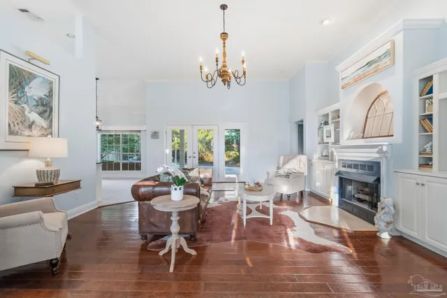 a living room with fireplace furniture and a chandelier