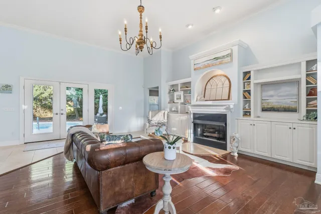 a living room with furniture a fireplace and a chandelier
