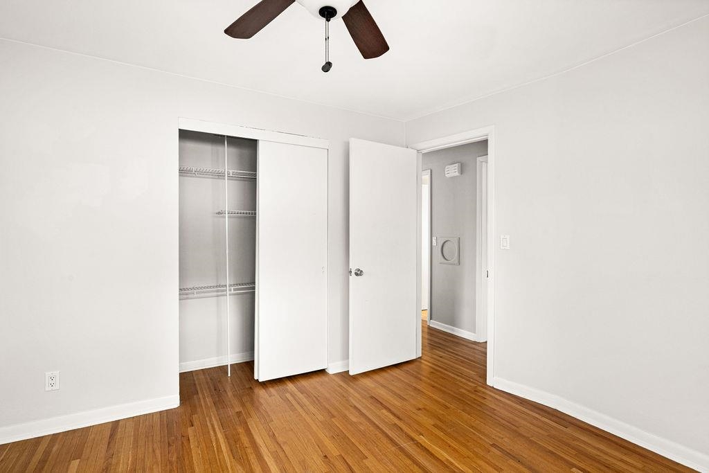5007 Colorado Street Duluth, MN 55804 - Photo 11 of 31 Unfurnished bedroom featuring wood finished floors, a closet, and a ceiling fan