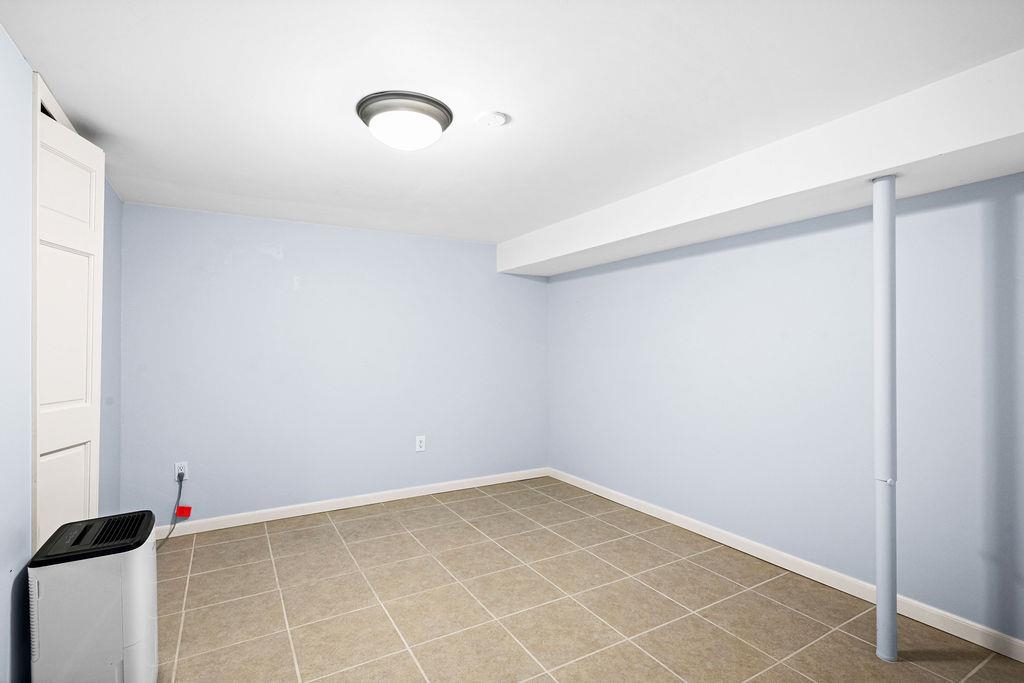 5007 Colorado Street Duluth, MN 55804 - Photo 14 of 31 Finished basement with baseboards and light tile patterned floors