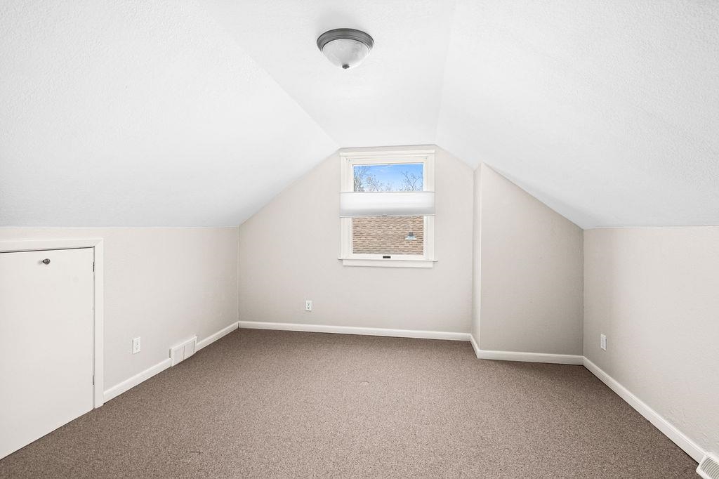 5007 Colorado Street Duluth, MN 55804 - Photo 16 of 31 Bonus room featuring carpet flooring, lofted ceiling, and a textured ceiling