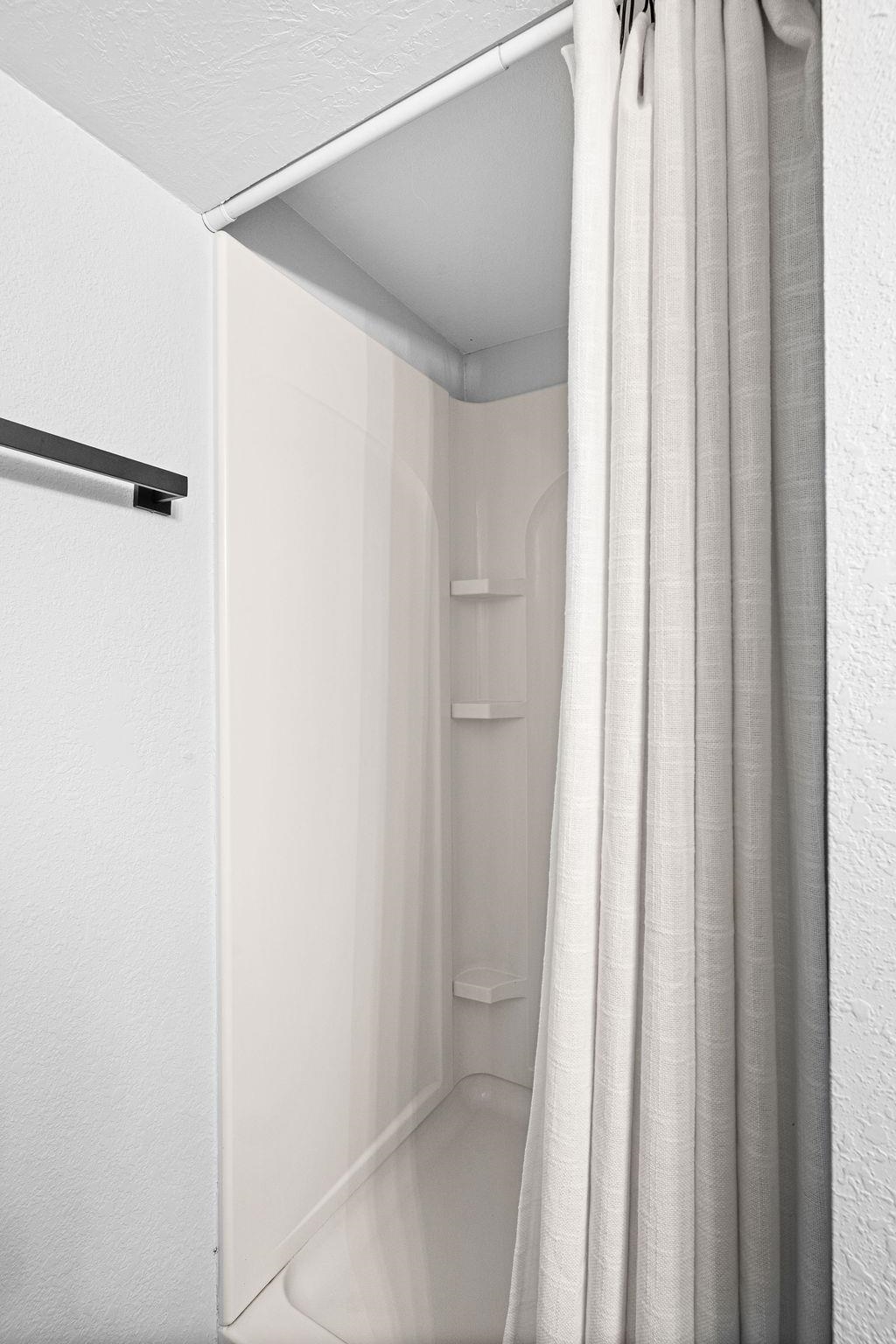 5007 Colorado Street Duluth, MN 55804 - Photo 22 of 31 Bathroom with a shower with shower curtain and a textured wall