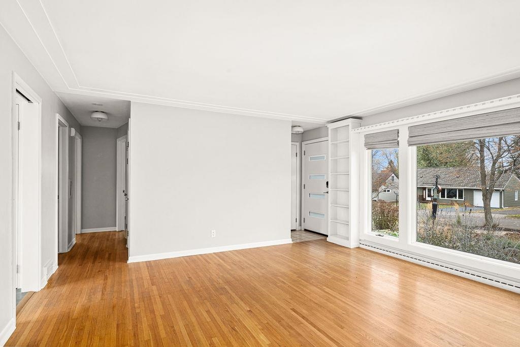 5007 Colorado Street Duluth, MN 55804 - Photo 7 of 31 Empty room featuring light wood-style flooring and a baseboard radiator