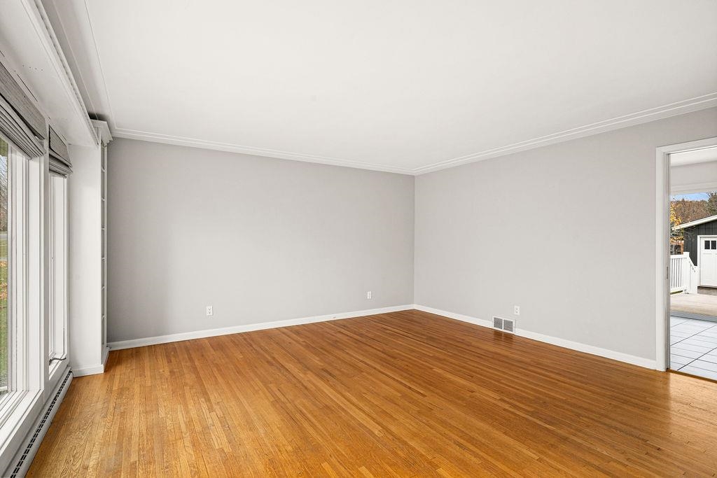 5007 Colorado Street Duluth, MN 55804 - Photo 8 of 31 Unfurnished bedroom featuring baseboard heating, light wood-type flooring, and crown molding