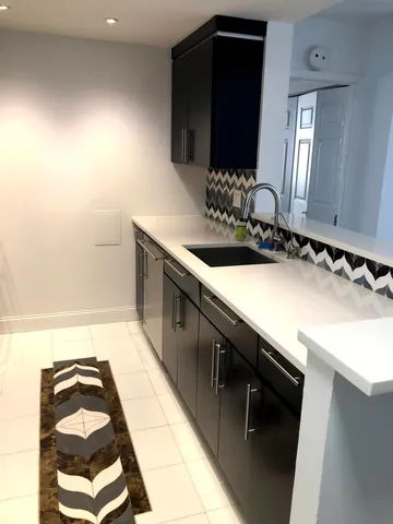 a kitchen with a sink and a stove