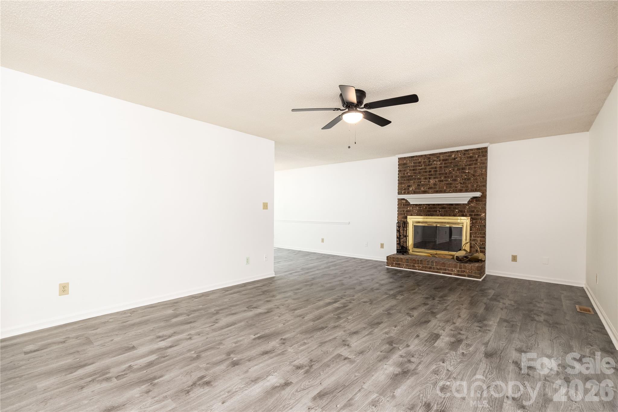 21014 Pine Ridge Drive Cornelius, NC 28031 - Photo 11 of 26 a view of an empty room with a fireplace and a window