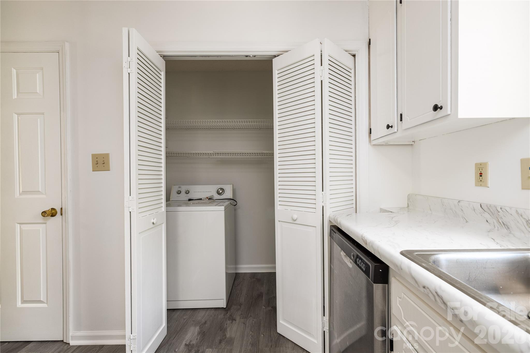21014 Pine Ridge Drive Cornelius, NC 28031 - Photo 12 of 26 a kitchen with a sink and a refrigerator