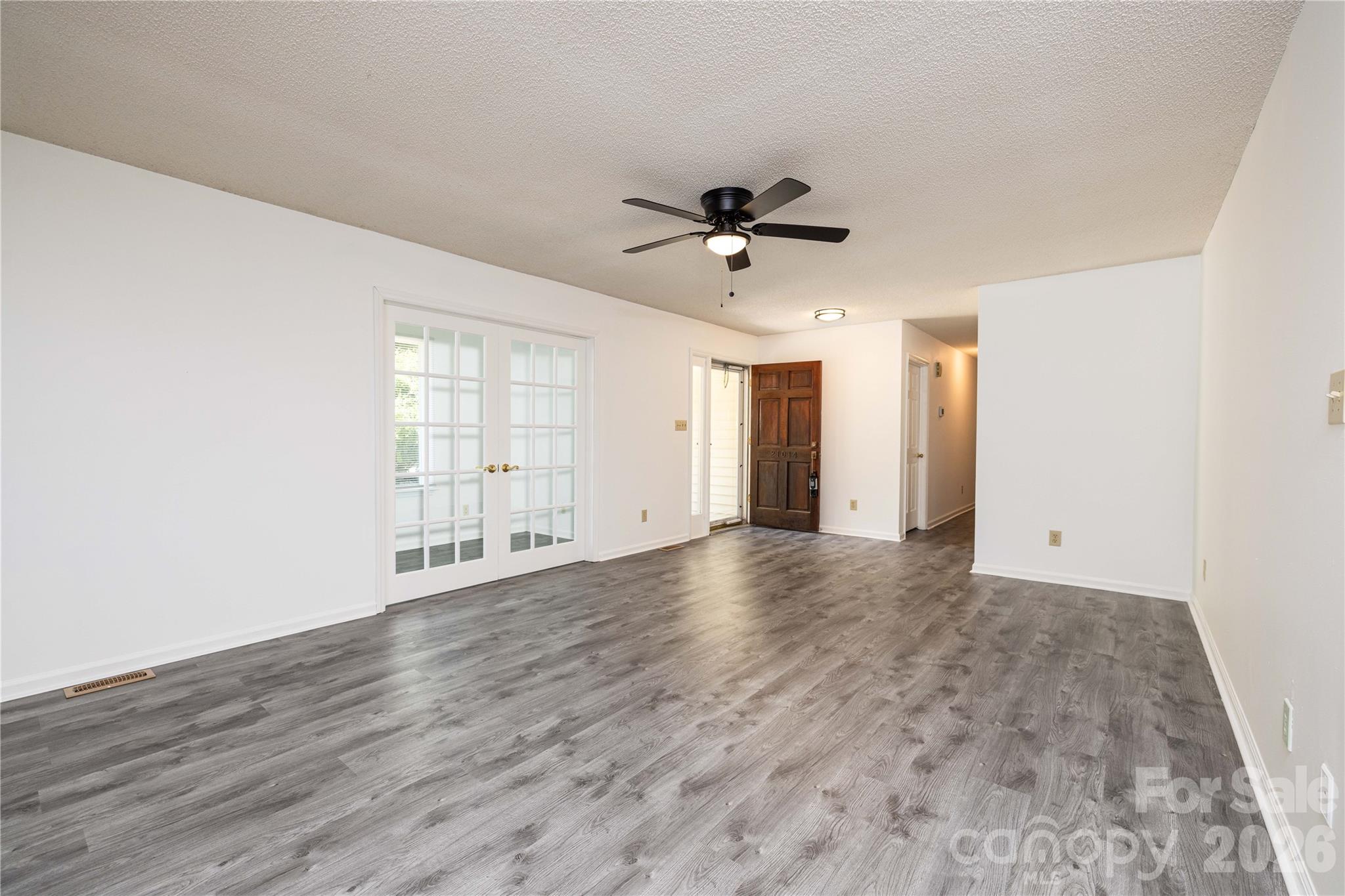 21014 Pine Ridge Drive Cornelius, NC 28031 - Photo 13 of 26 a view of empty room with wooden floor and fan