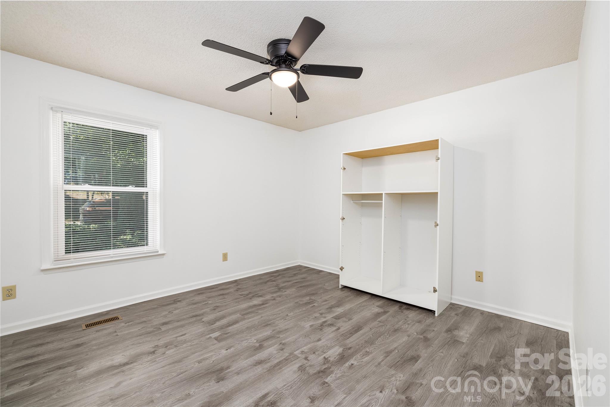21014 Pine Ridge Drive Cornelius, NC 28031 - Photo 17 of 26 an empty room with a window and a ceiling fan