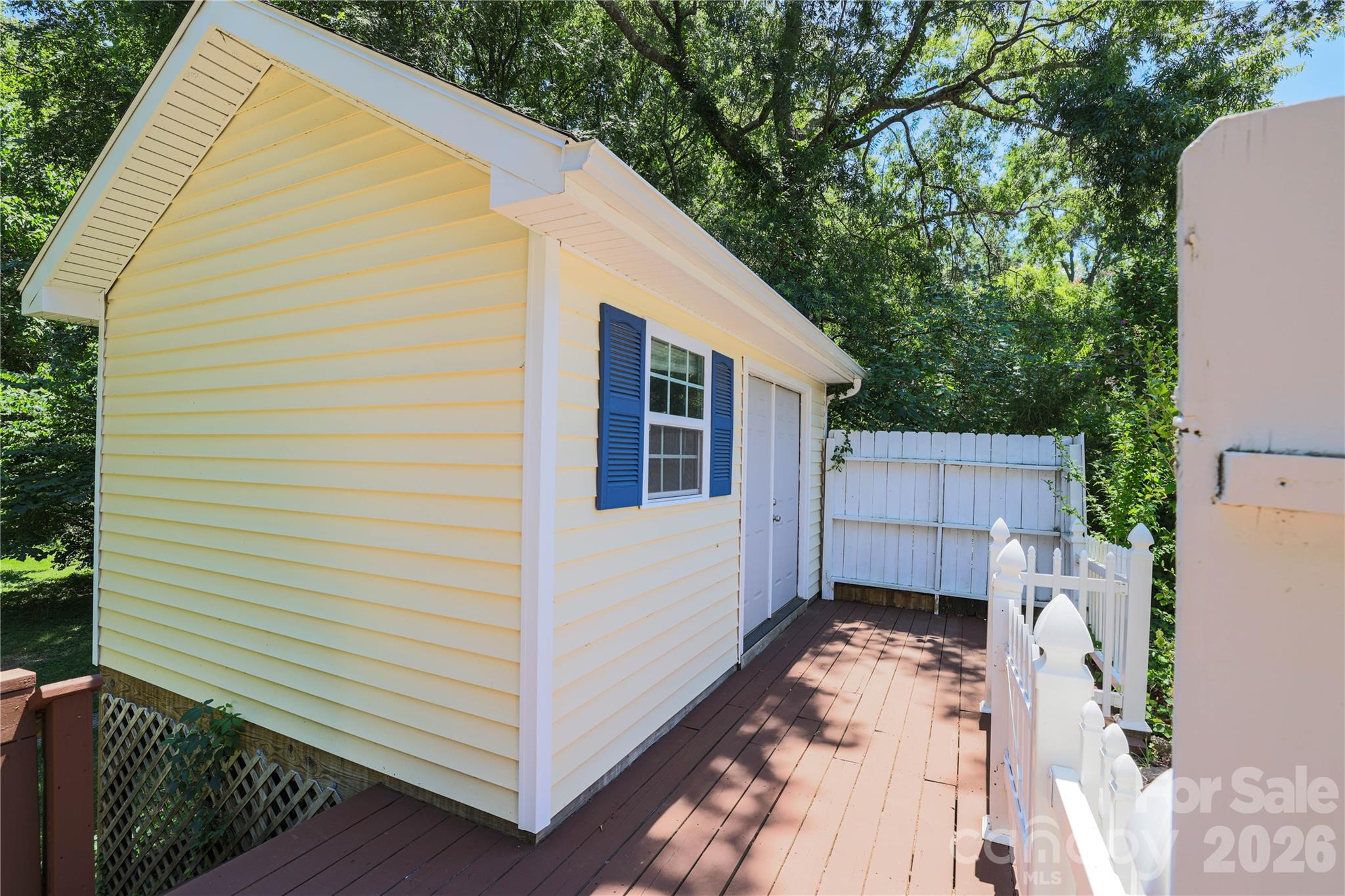 21014 Pine Ridge Drive Cornelius, NC 28031 - Photo 24 of 26 a view of a small house with wooden fence