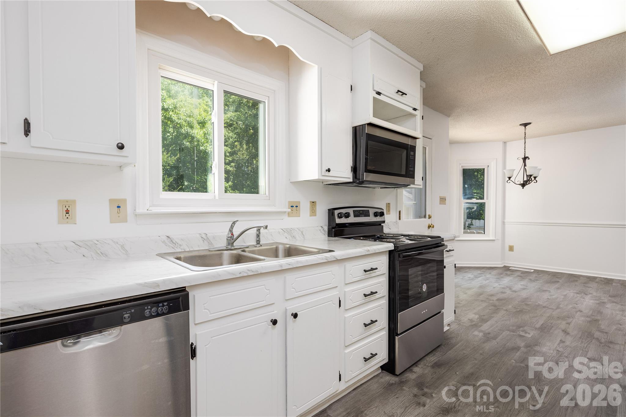 21014 Pine Ridge Drive Cornelius, NC 28031 - Photo 4 of 26 a kitchen with appliances a sink and a window