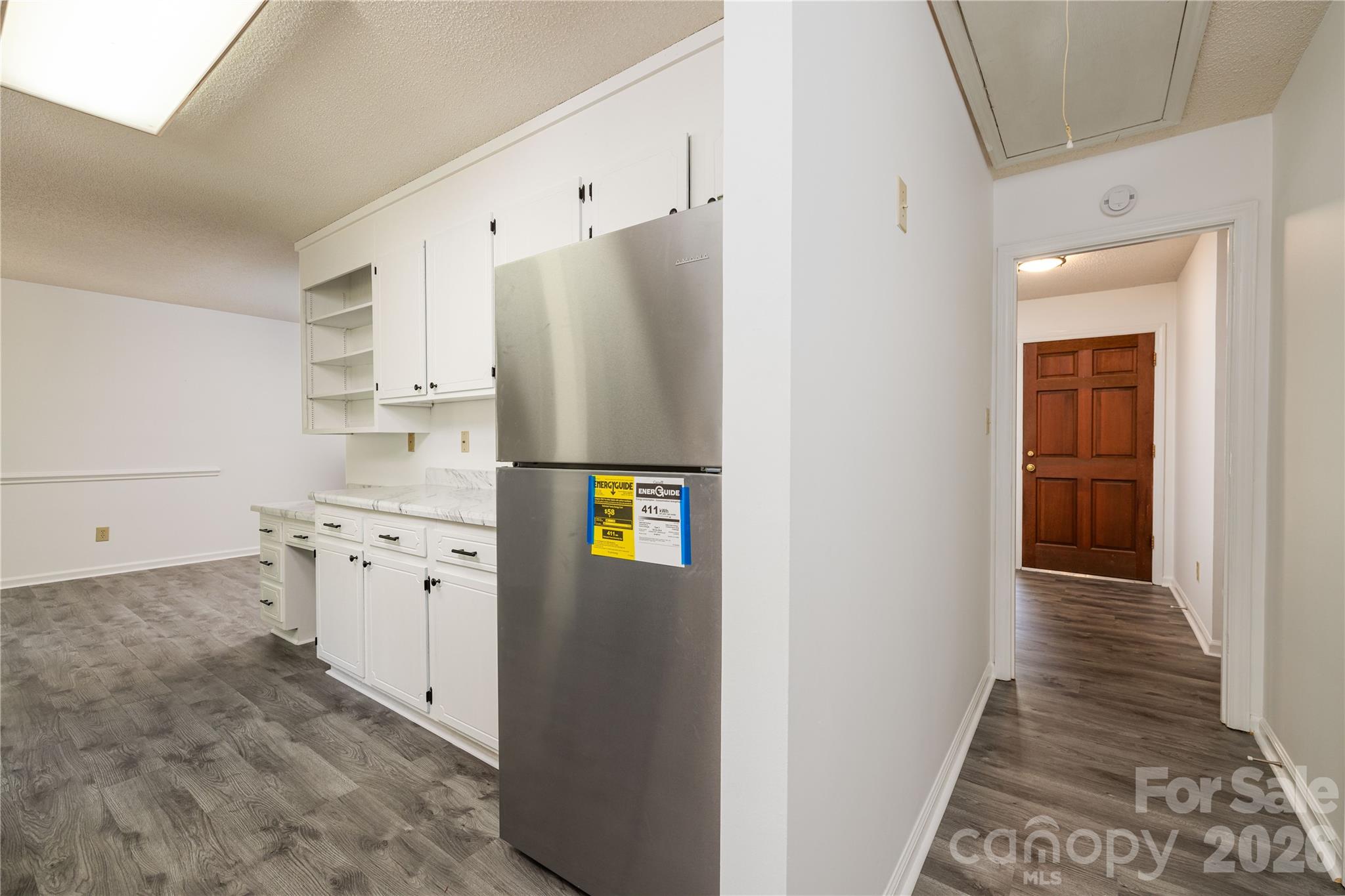 21014 Pine Ridge Drive Cornelius, NC 28031 - Photo 9 of 26 a kitchen with stainless steel appliances a refrigerator and a stove