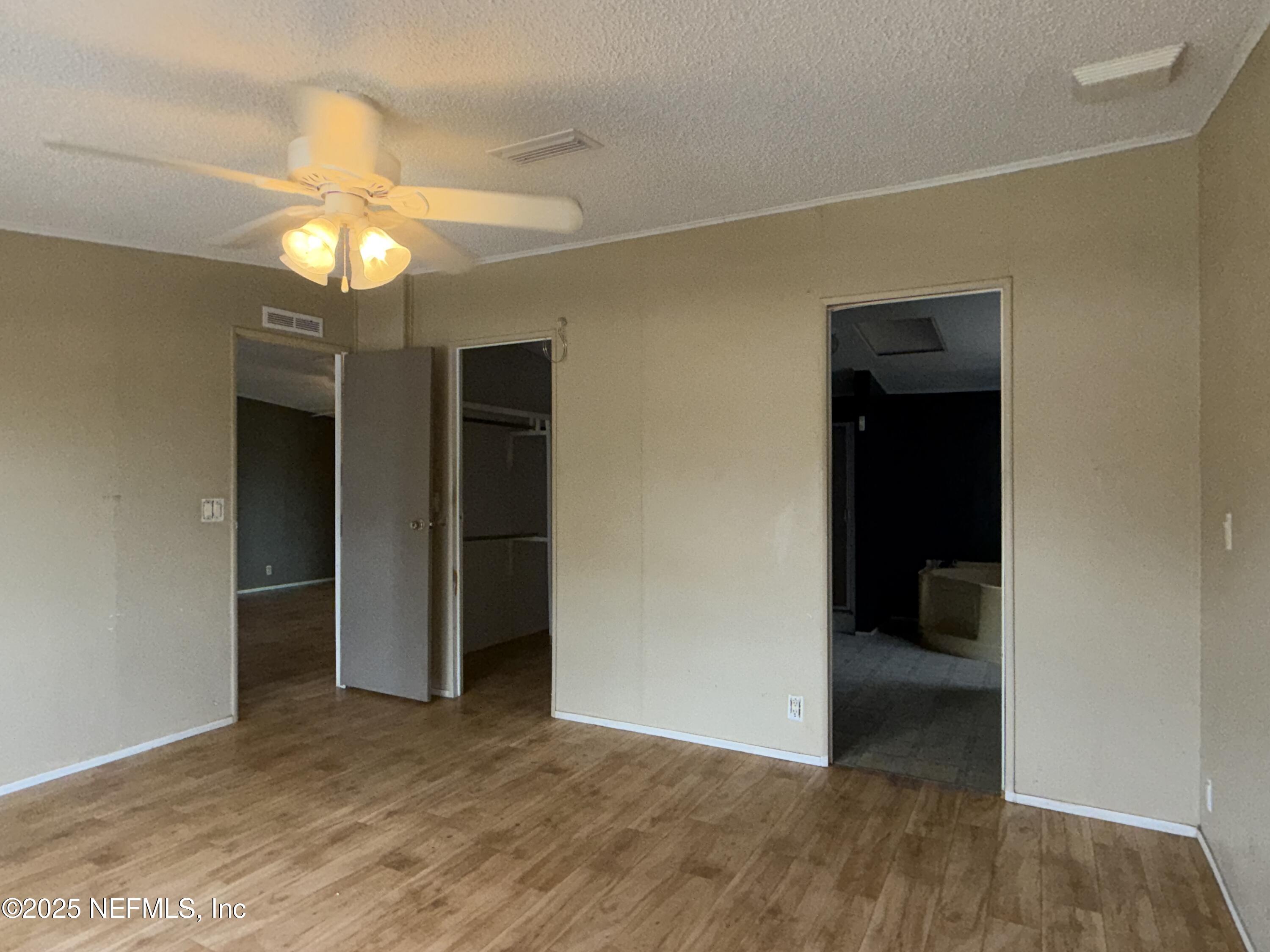 323 Incline Road Satsuma, FL 32189 - Photo 8 of 12 a view of an empty room with a window and a kitchen