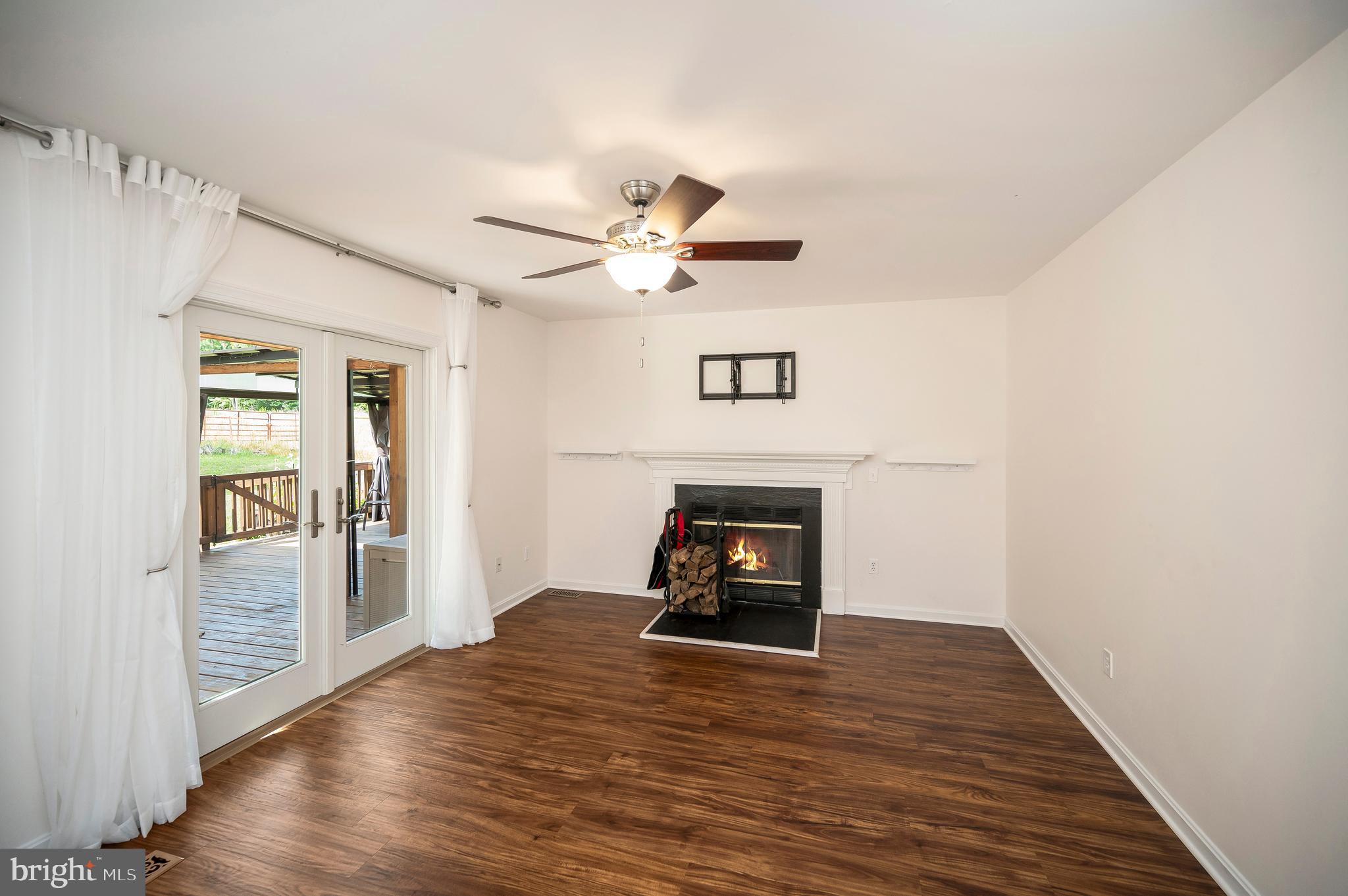 633 Welsh Drive Ruther Glen, VA 22546 - Photo 16 of 71 Family room with LTV flooring and fireplace