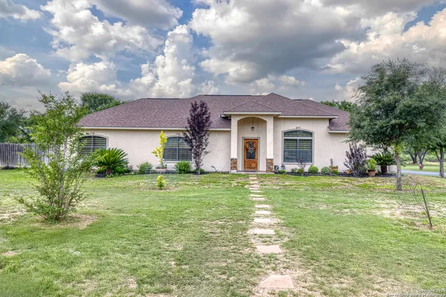 a backyard of a house with table and chairs