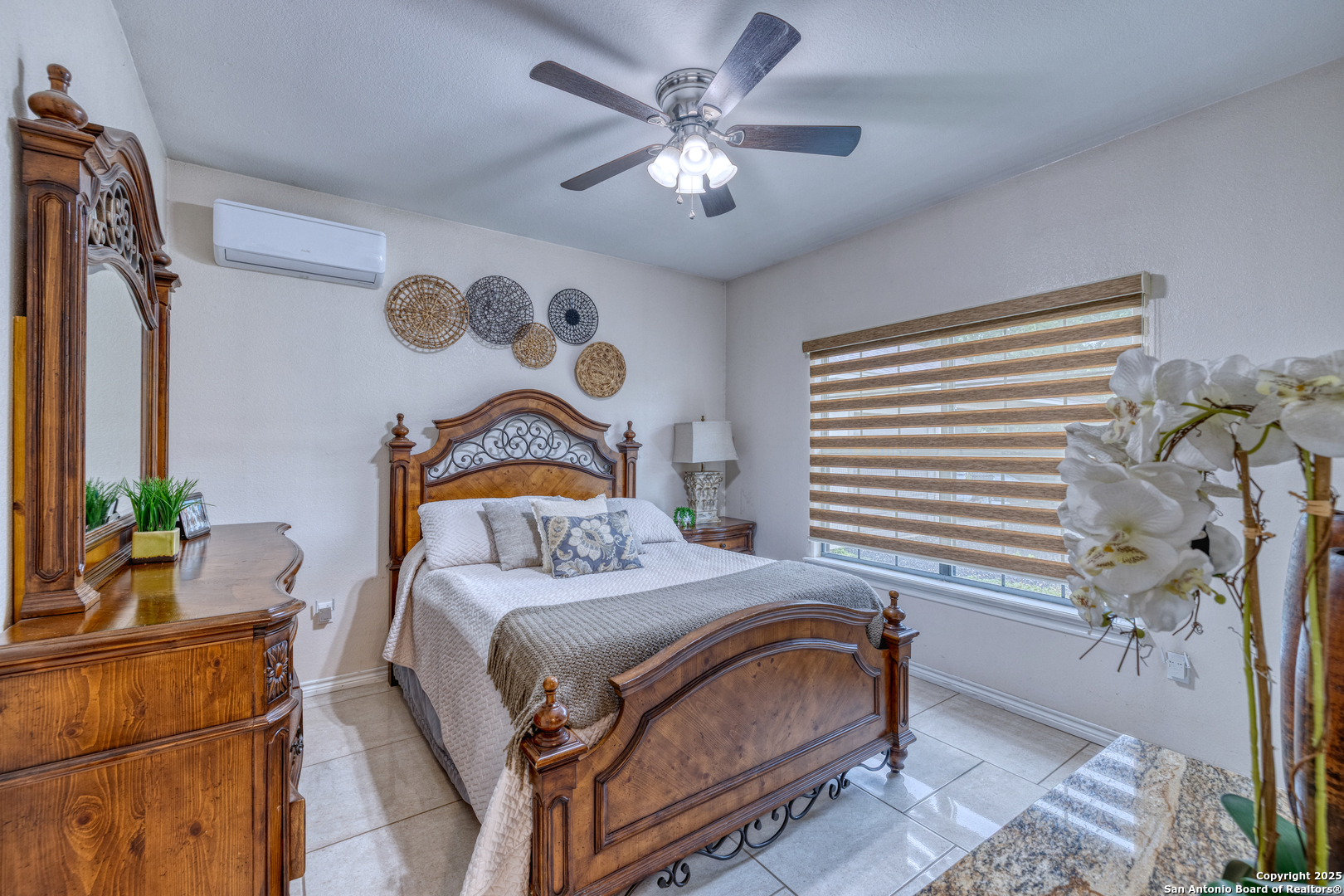 333 Studer Street Uvalde, TX 78801 - Photo 19 of 29 a bedroom with a bed and a chandelier