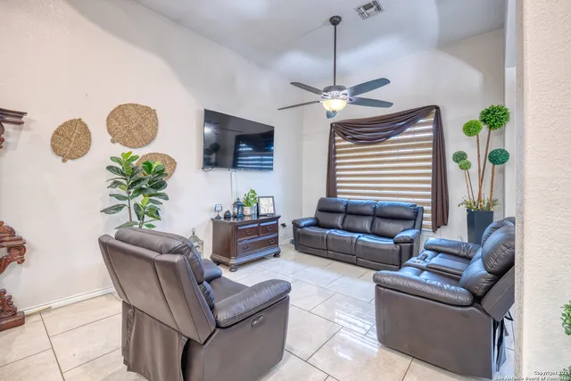 a living room with furniture a chandelier and a window
