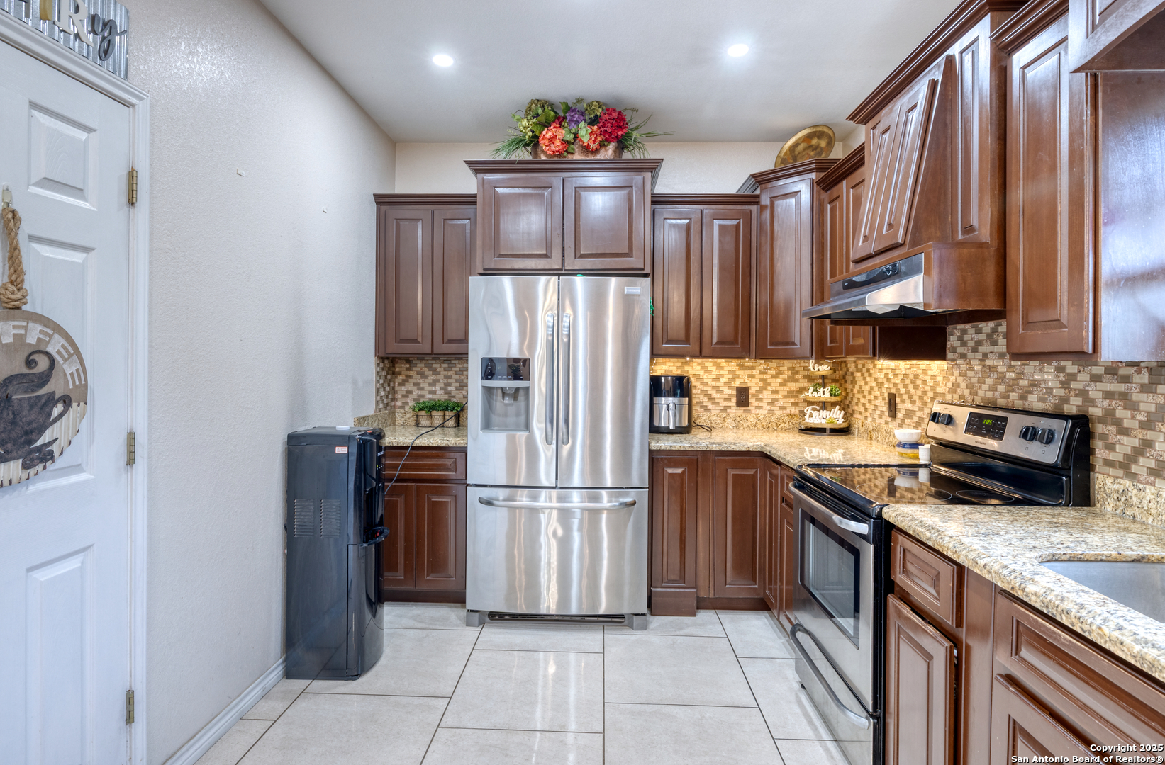 333 Studer Street Uvalde, TX 78801 - Photo 7 of 29 a kitchen with stainless steel appliances granite countertop a refrigerator stove a sink and dishwasher